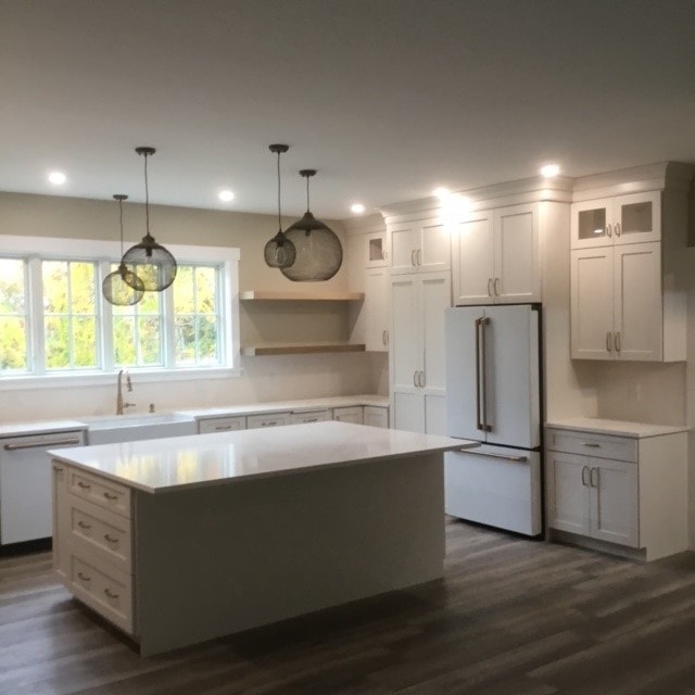 Custom New Build kitchen with white shaker cabinets, quartz island, globe pendant lights, and farmhouse sink — Bedford, NH