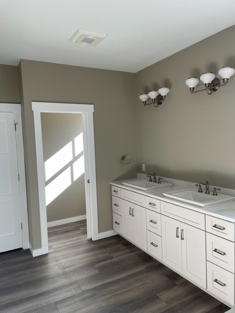 Custom New Build master bath with dual-sink white vanity, quartz countertop, taupe walls, and sconce lighting — Bedford, NH