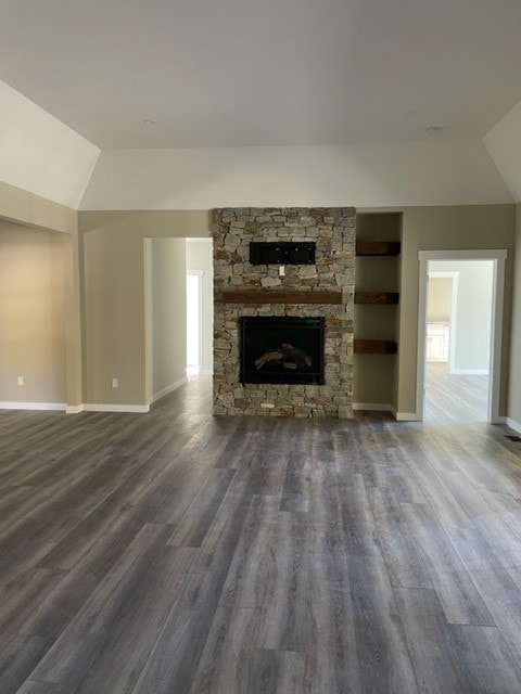 Custom New Build great room with vaulted ceiling, floor-to-ceiling stone fireplace, wood mantel, and built-in shelving — Bedford, NH