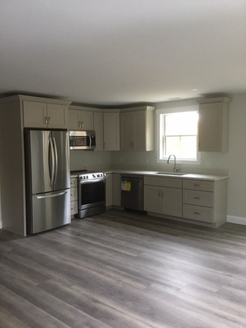Custom New Build kitchen with gray shaker cabinets, stainless appliances, quartz countertops, and wide-plank floors — Bedford, NH