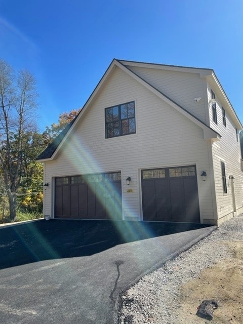 Custom New Build detached two-car garage with dark carriage doors and new asphalt driveway — Bedford, NH