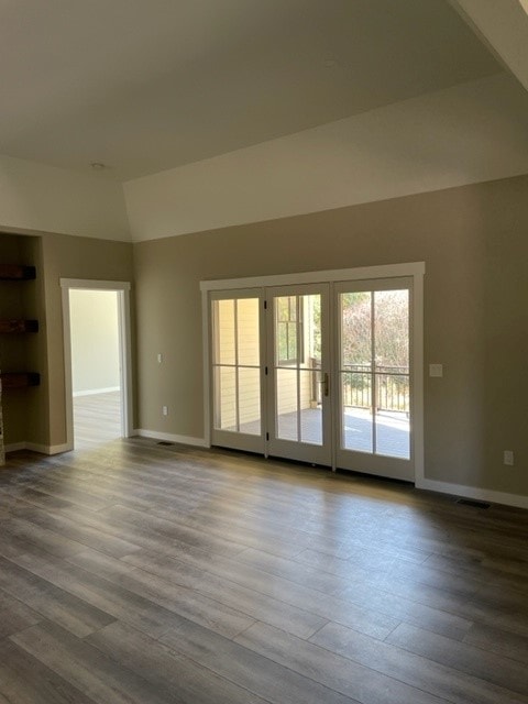 Custom New Build great room with vaulted ceiling, French doors to deck, and wide-plank hardwood floors — Bedford, NH