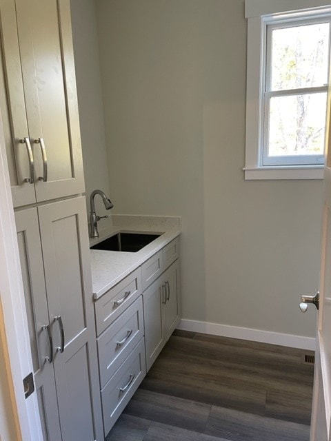 Custom New Build mudroom with gray shaker cabinets, quartz countertop, undermount sink, and wide-plank floors — Bedford, NH