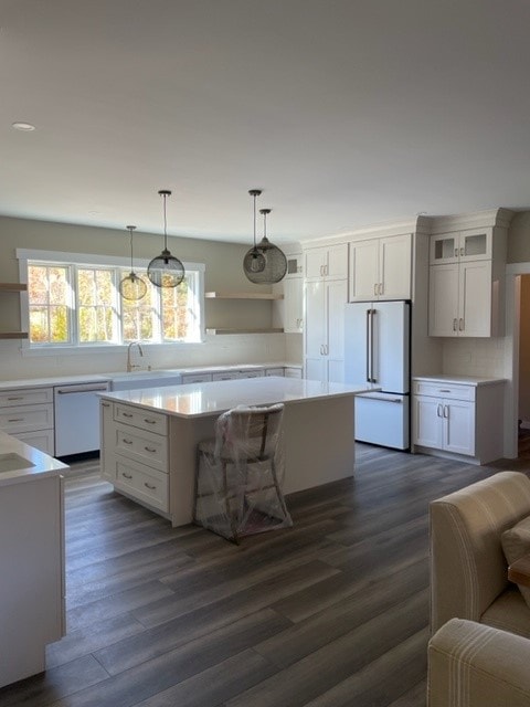 Custom New Build kitchen showing quartz island, white shaker cabinets, floating shelves, and panel-ready refrigerator — Bedford, NH