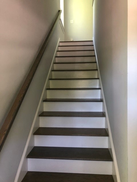 Mason New Build staircase with dark wood treads, white risers, and wood handrail — Governor's Crossing, NH