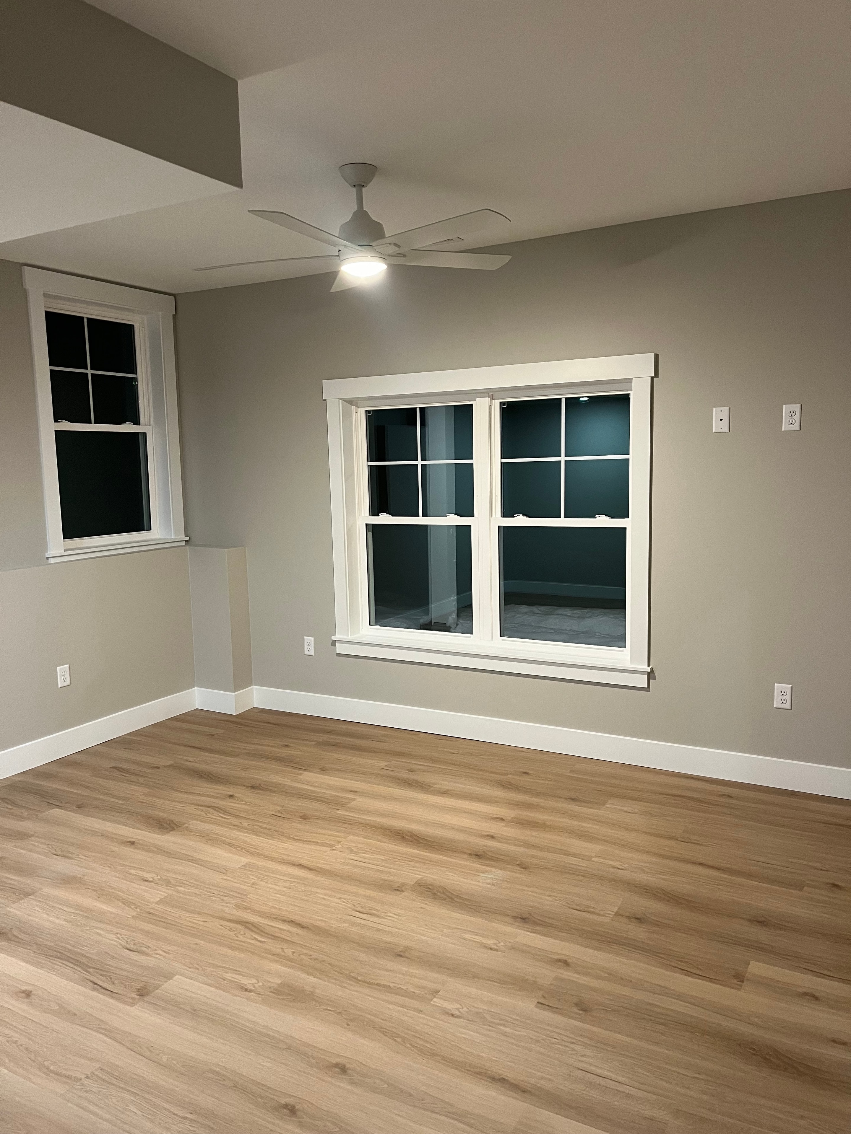 Mountain View Home bedroom with gray walls, white trim, craftsman window, and oak hardwood floors