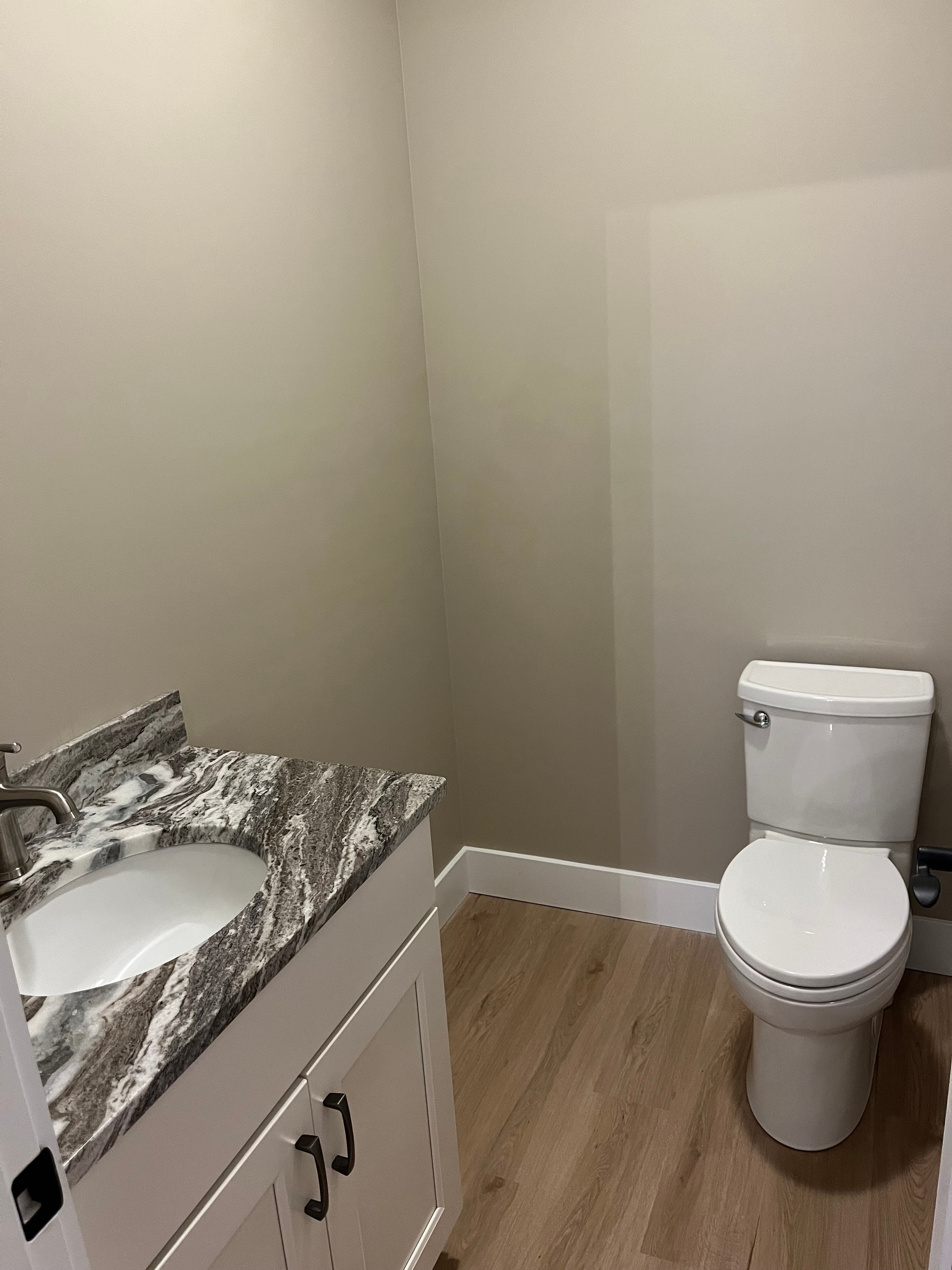 Mountain View Home powder bath with white shaker vanity, granite countertop, and undermount sink