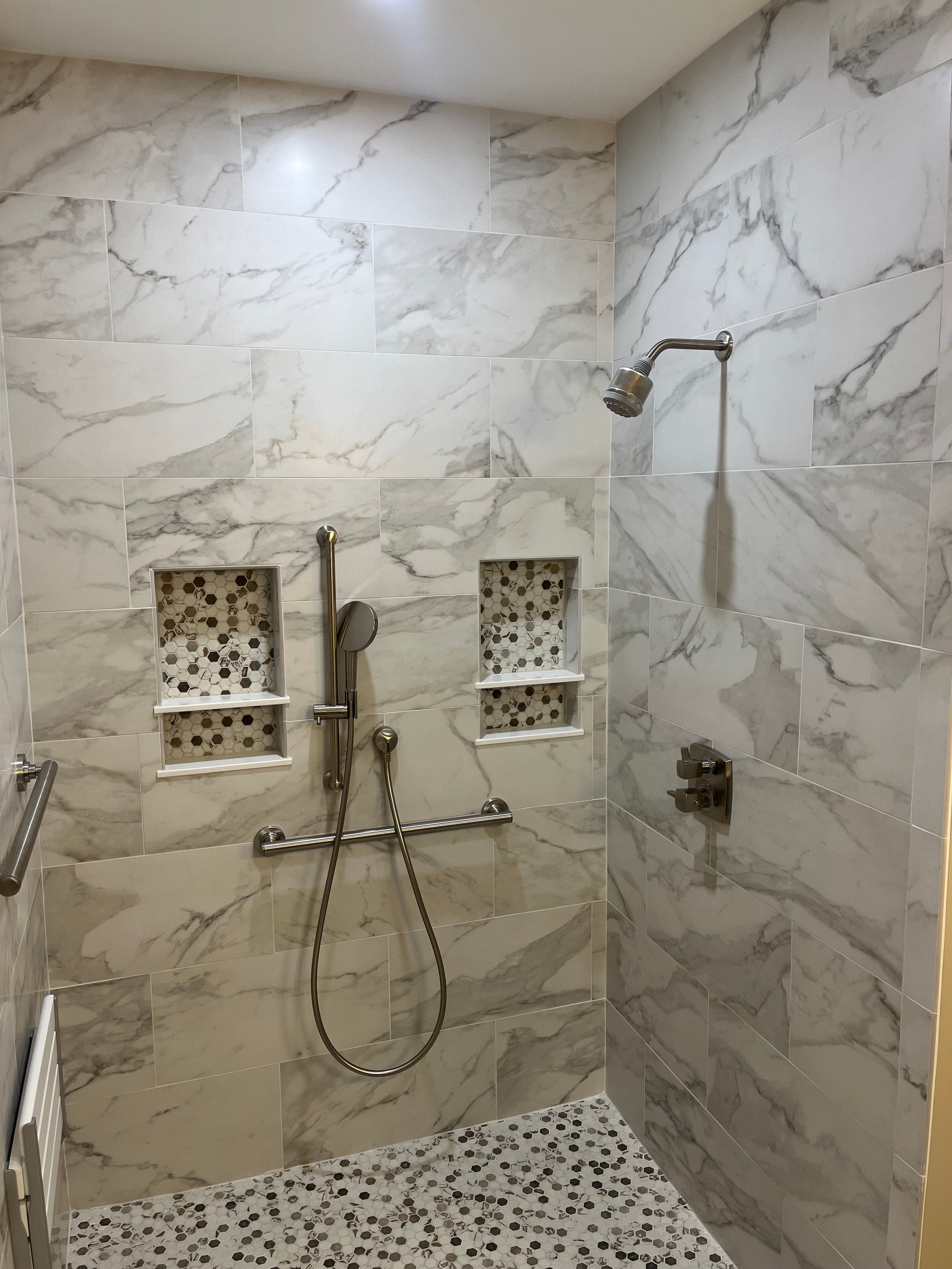 Mountain View Home master shower with large-format marble tile, mosaic hex niches, and brushed nickel fixtures