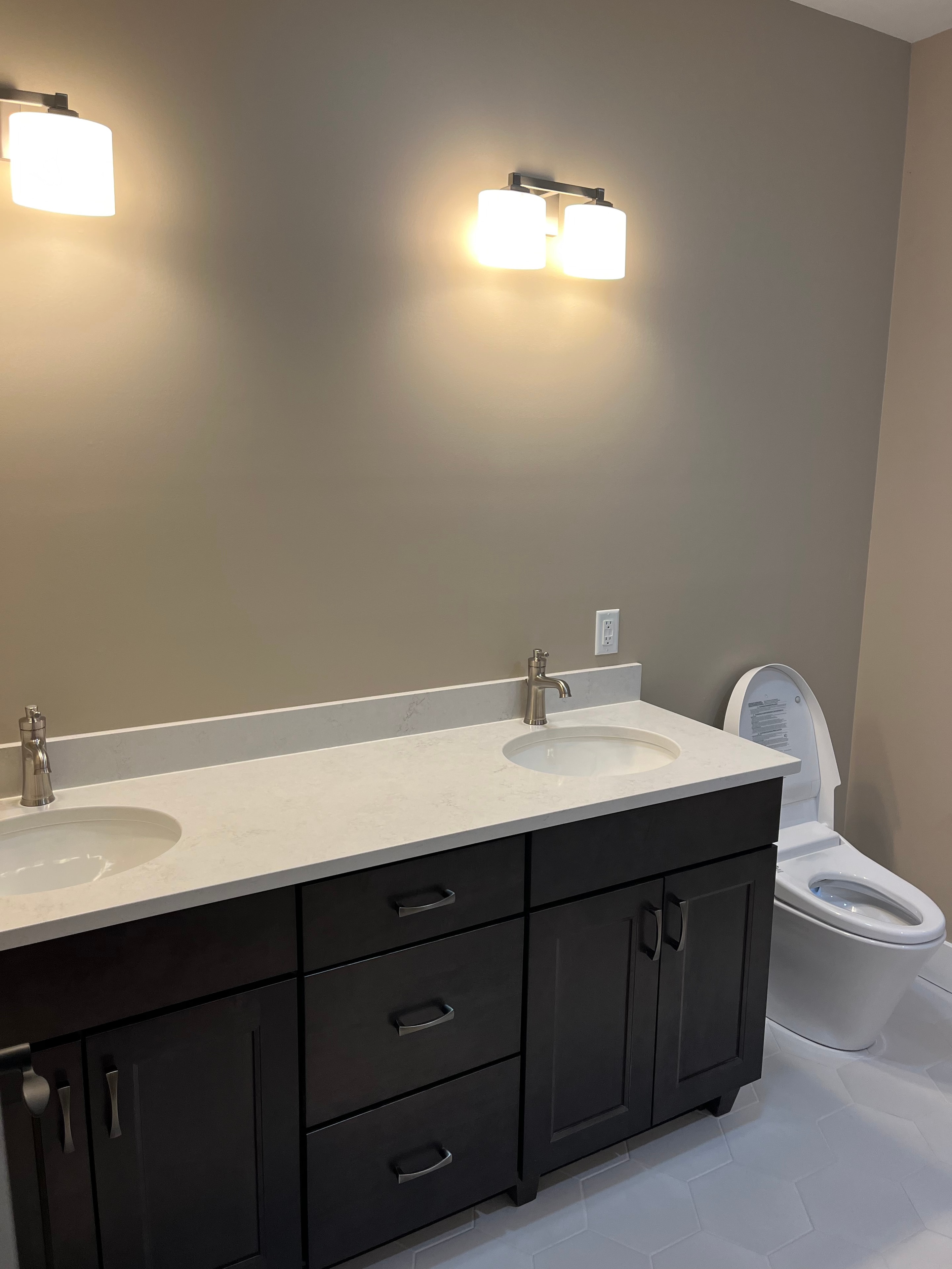 Mountain View Home master bath with dark espresso double vanity, quartz countertop, and globe wall sconces