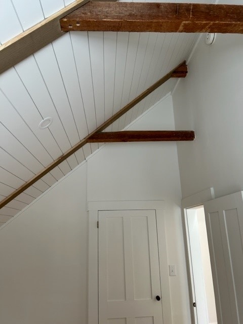 Partial Home Remodel vaulted attic room with white shiplap ceiling, two exposed beams, shaker doors, and pine hardwood floors — Meredith, NH