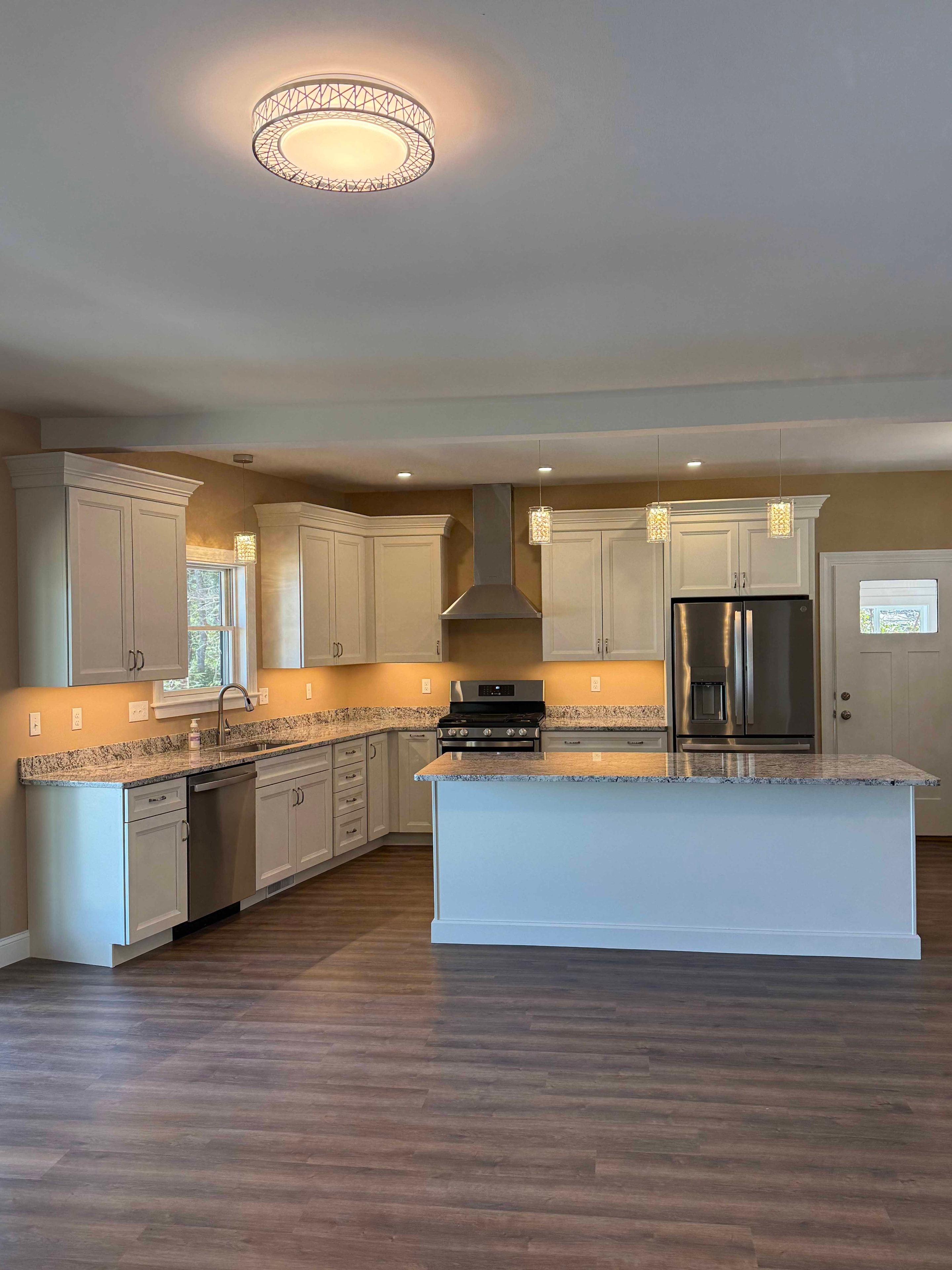 Squam Lake Home living room with built-in cabinetry, fireplace, and under-cabinet lighting
