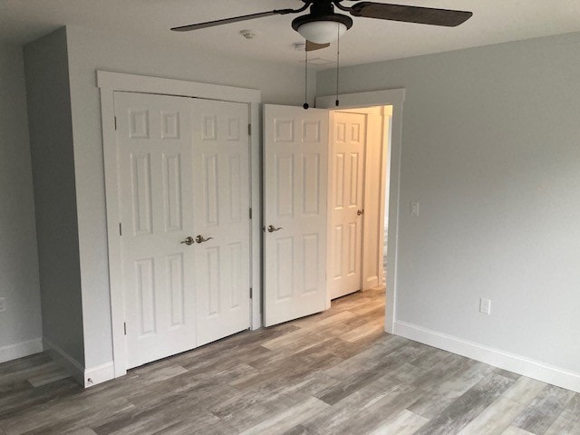 Wentworth New Build bedroom with double closet doors, ceiling fan, and wide-plank wood-look floors — Governor's Crossing, NH