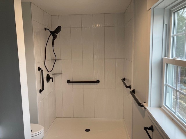 Wentworth New Build walk-in shower with white vertical subway tile, matte black fixtures, grab bars, and window — Governor's Crossing, NH