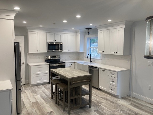 Wentworth New Build kitchen with white shaker cabinets, quartz countertops, stainless appliances, farmhouse sink, and butcher block island — Governor's Crossing, NH