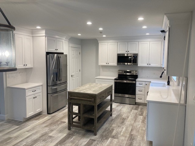 Wentworth New Build kitchen showing stainless refrigerator, white shaker cabinets, quartz countertops, and butcher block island — Governor's Crossing, NH