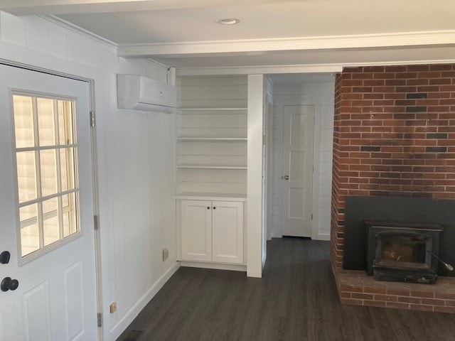 Lake Winnisquam Cottage Remodel living room with white shiplap walls, brick fireplace, built-in shelving, and mini-split — Winnisquam, NH